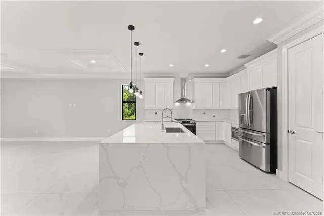 a kitchen with stainless steel appliances a refrigerator sink and stove