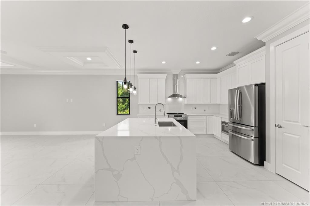 5460 Southeast Front Avenue Stuart, FL 34997 - Photo 10 of 40 a kitchen with stainless steel appliances a refrigerator sink and stove