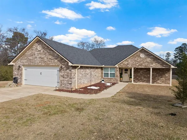 a view of a house with a yard and garage