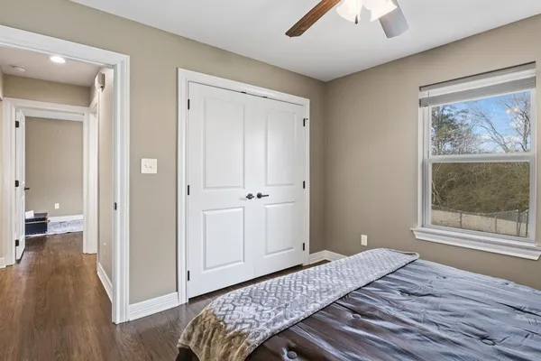 a bedroom with a bed and a window