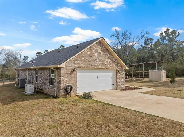 a view of a house with a yard and garage