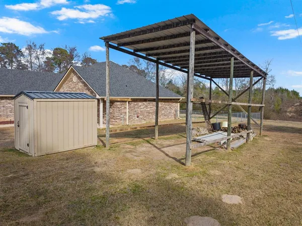a view of a house with backyard and sitting area