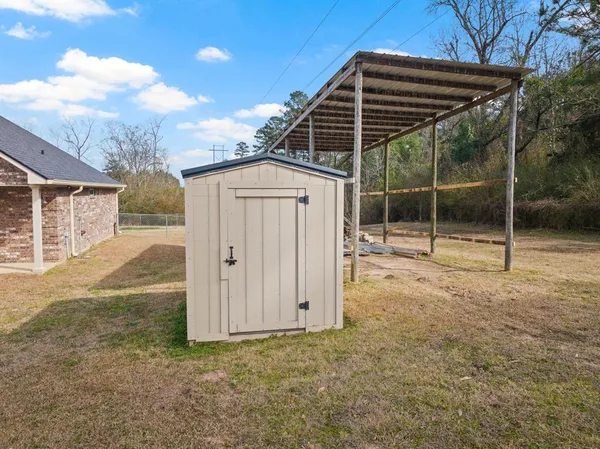 a backyard of a house with portable swimming pool and barbeque oven