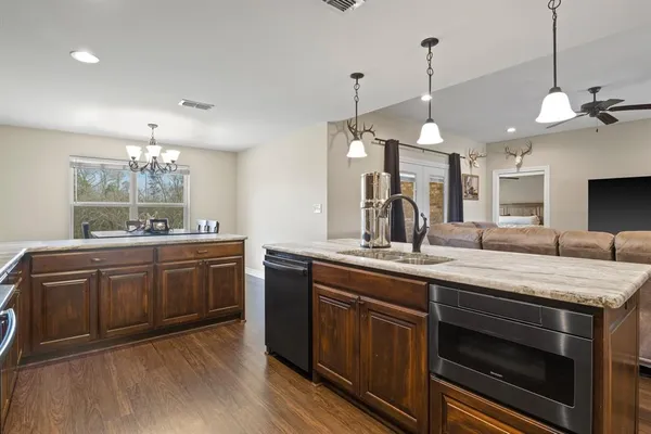a kitchen with a sink stove and cabinets