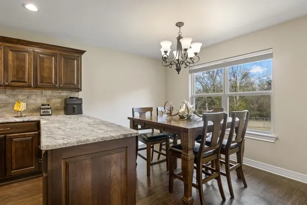 a view of a dining room with furniture window and outside view