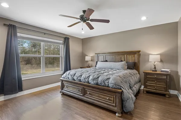 a bedroom with a bed and a large window