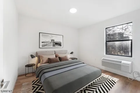 a bedroom with a bed and a painting on the wall