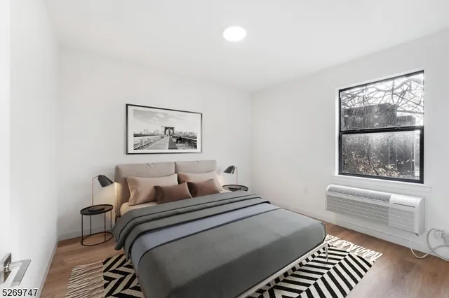 a bedroom with a bed and a painting on the wall