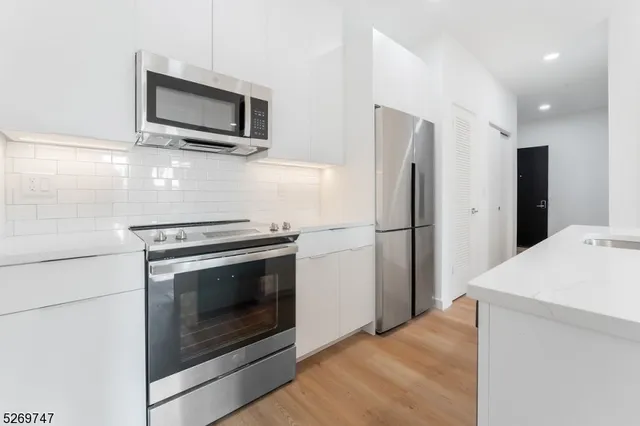 a stove top oven sitting inside of a kitchen