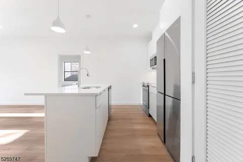 a kitchen with stainless steel appliances a refrigerator and a stove