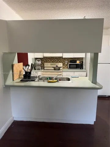 a close view of dining table with chairs