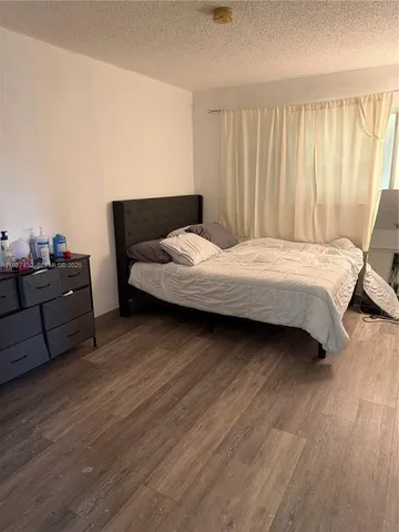 a bedroom with a bed and couch