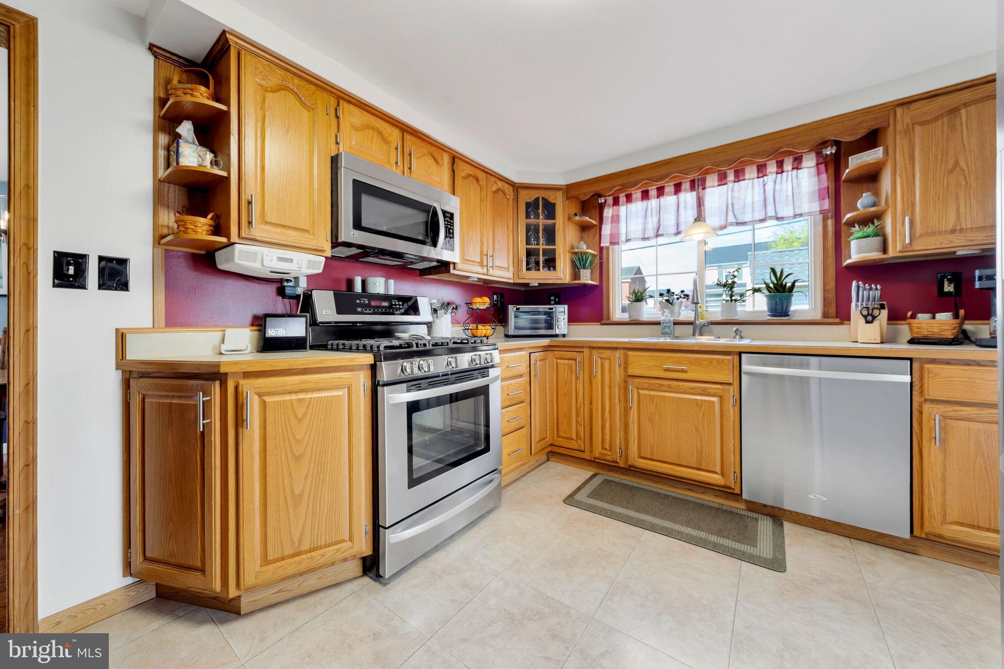 409 Holmes Road Morton, PA 19070 - Photo 11 of 55 a kitchen with a stove top oven sink and cabinets