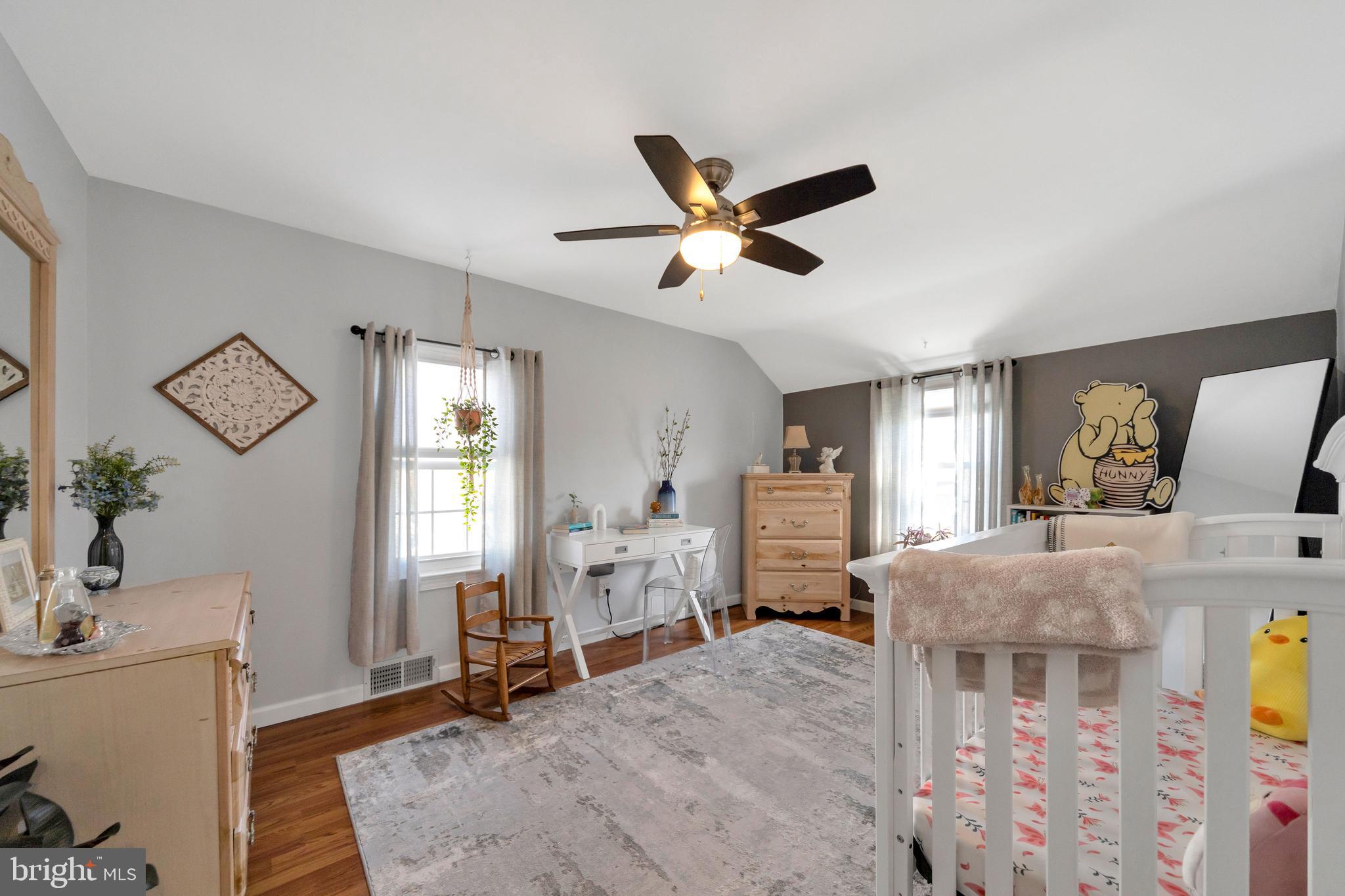 409 Holmes Road Morton, PA 19070 - Photo 21 of 55 a bedroom with a bed and a chandelier