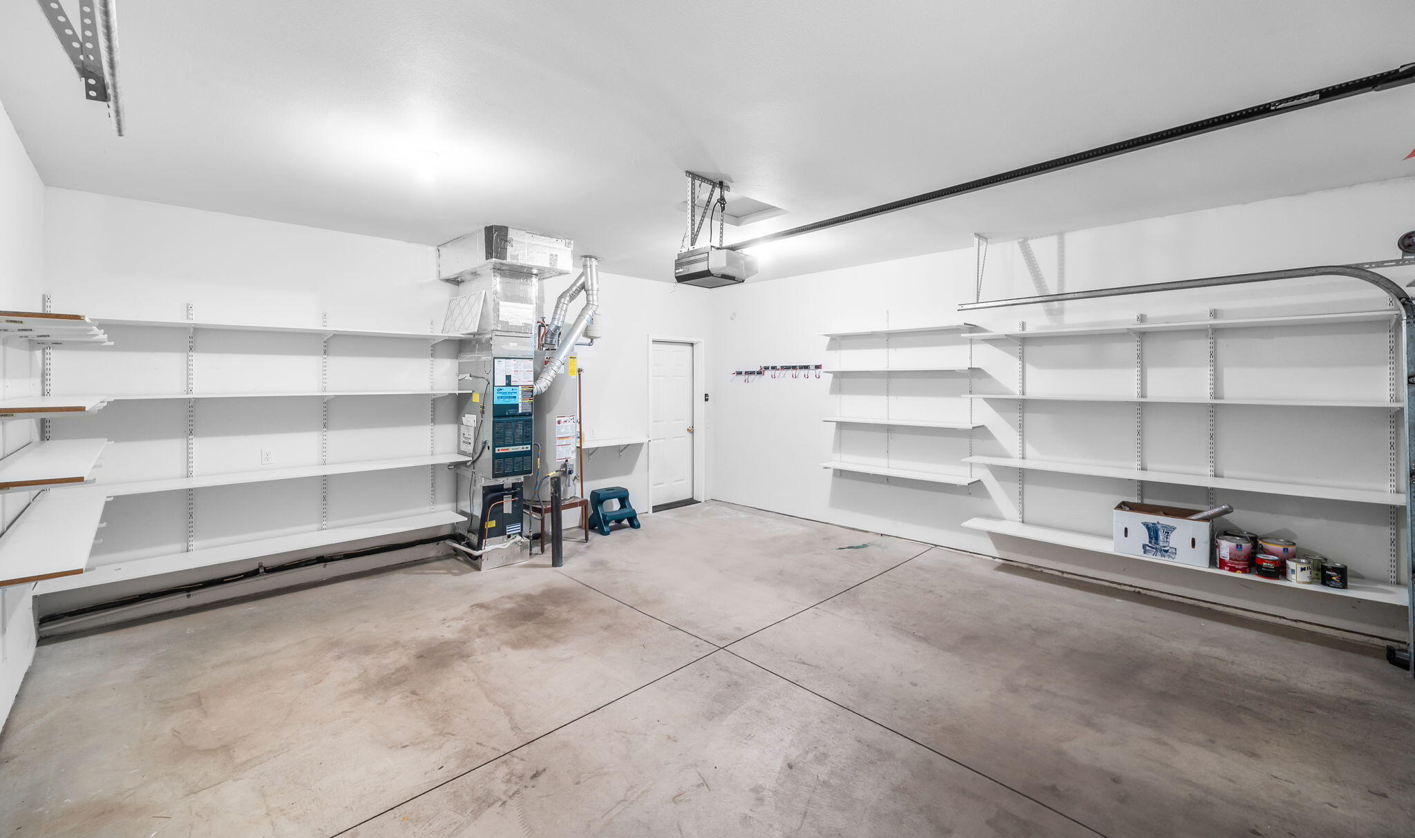 61311 Southwest Brookside Loop Bend, OR 97702 - Photo 27 of 30 Double car garage with attached shelving.