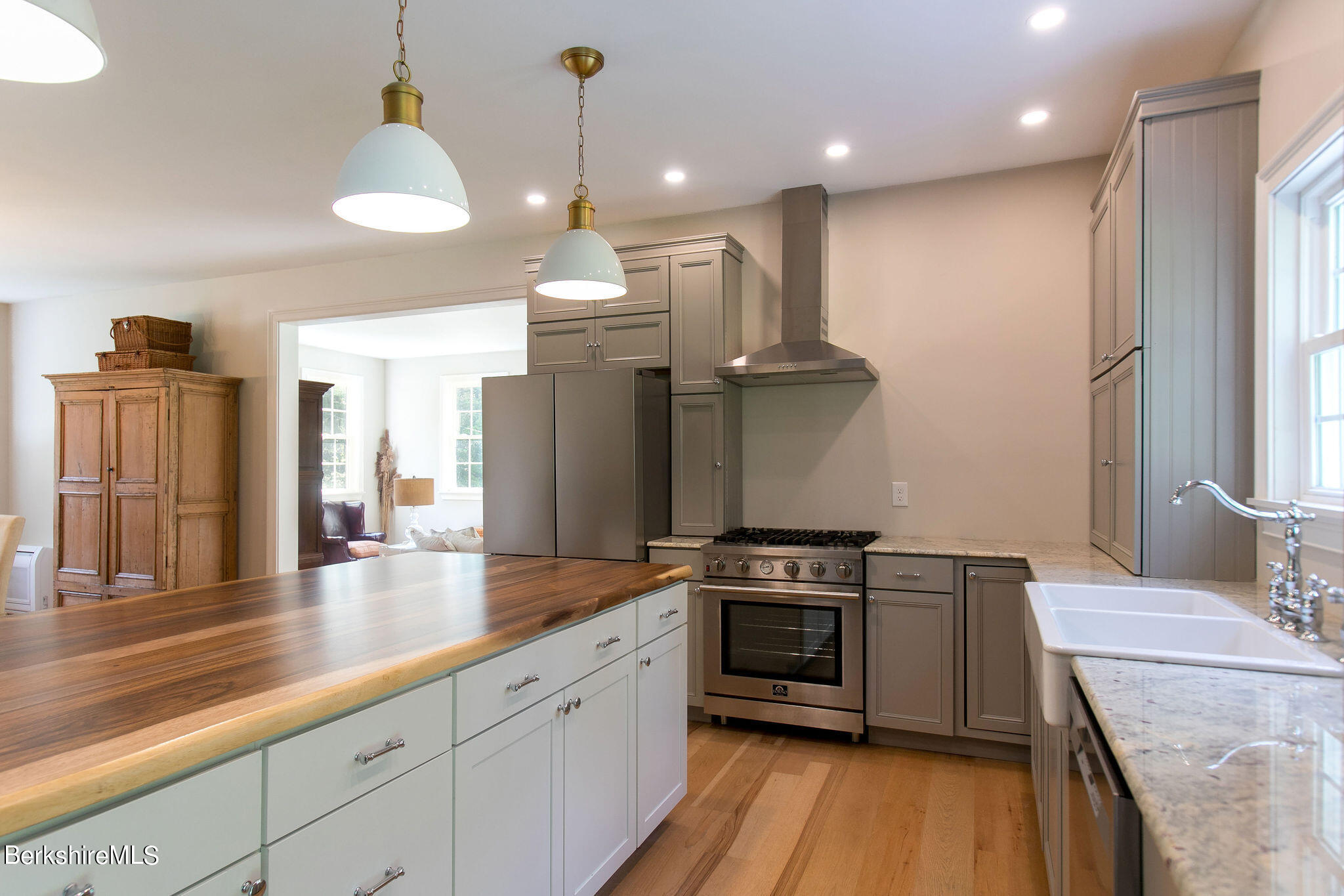 897 Canaan Valley Road New Marlborough, MA 01259 - Photo 11 of 50 a kitchen with stainless steel appliances granite countertop a sink a stove and a wooden floors
