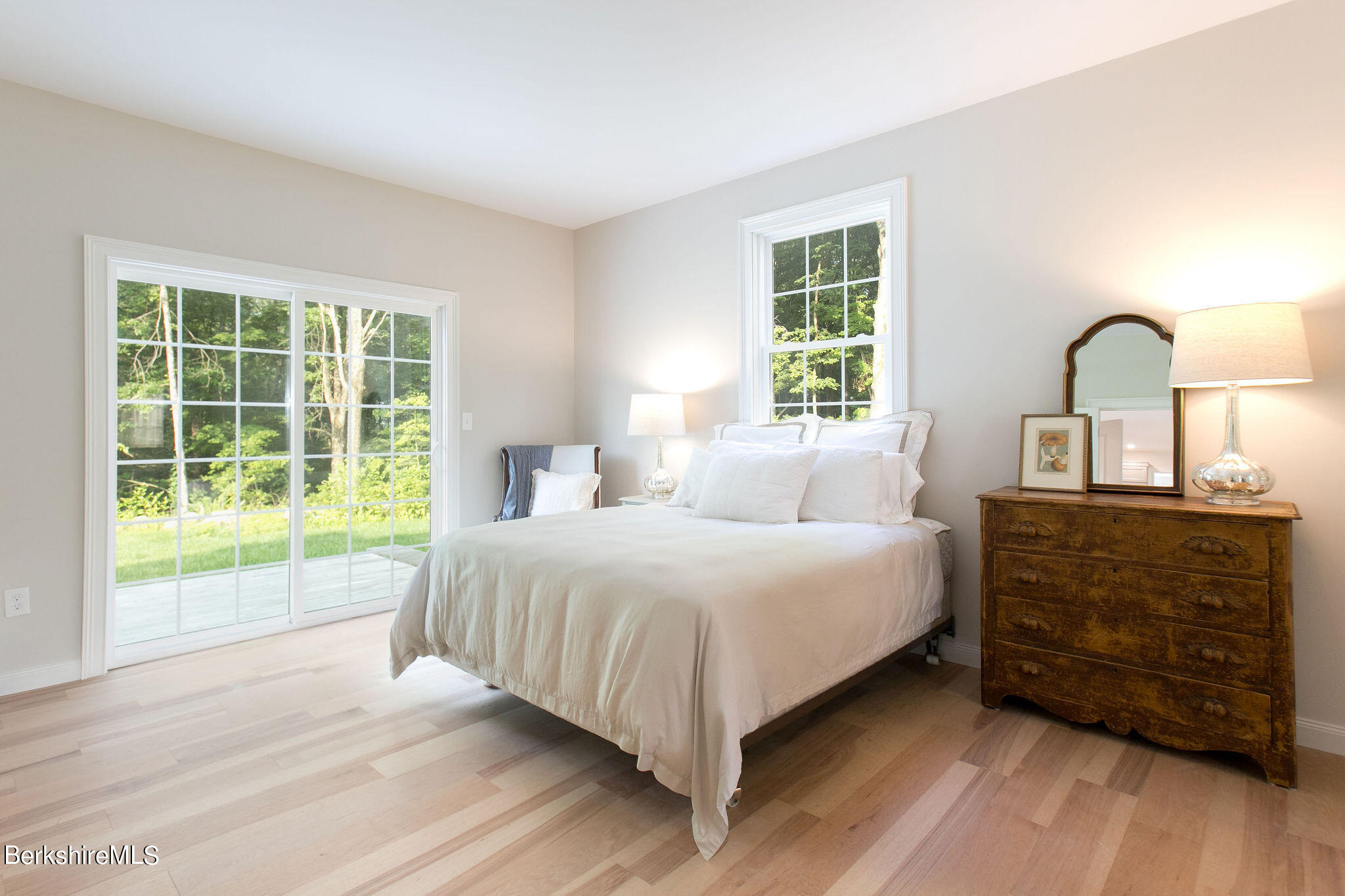 897 Canaan Valley Road New Marlborough, MA 01259 - Photo 19 of 50 a bedroom with a bed and a dresser next to a window