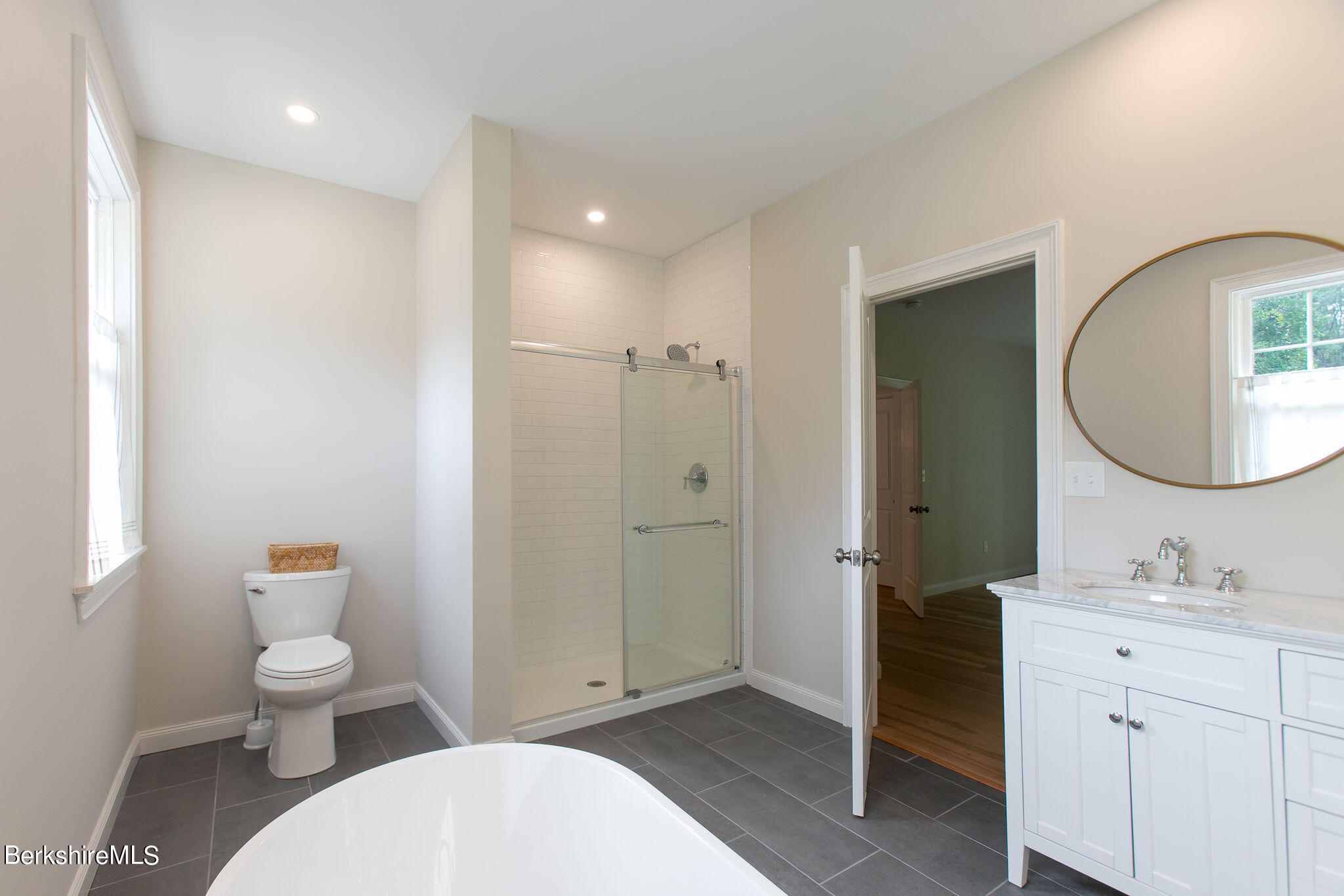 897 Canaan Valley Road New Marlborough, MA 01259 - Photo 25 of 50 a bathroom with a toilet a sink a mirror and a shower
