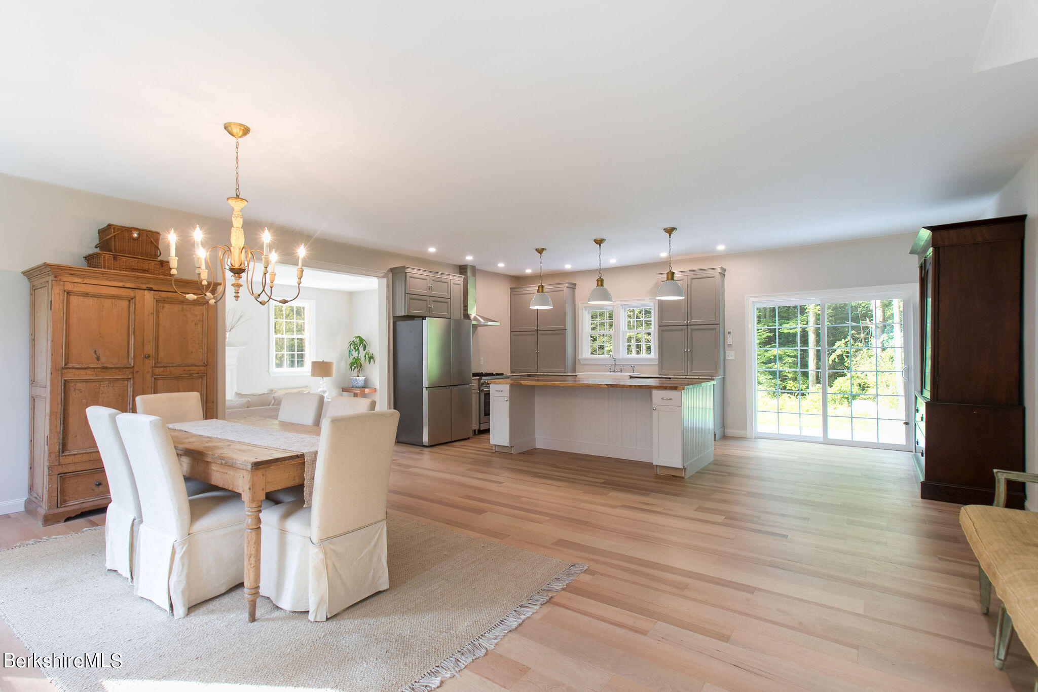 897 Canaan Valley Road New Marlborough, MA 01259 - Photo 4 of 50 a view of a dining room and livingroom with furniture wooden floor a chandelier