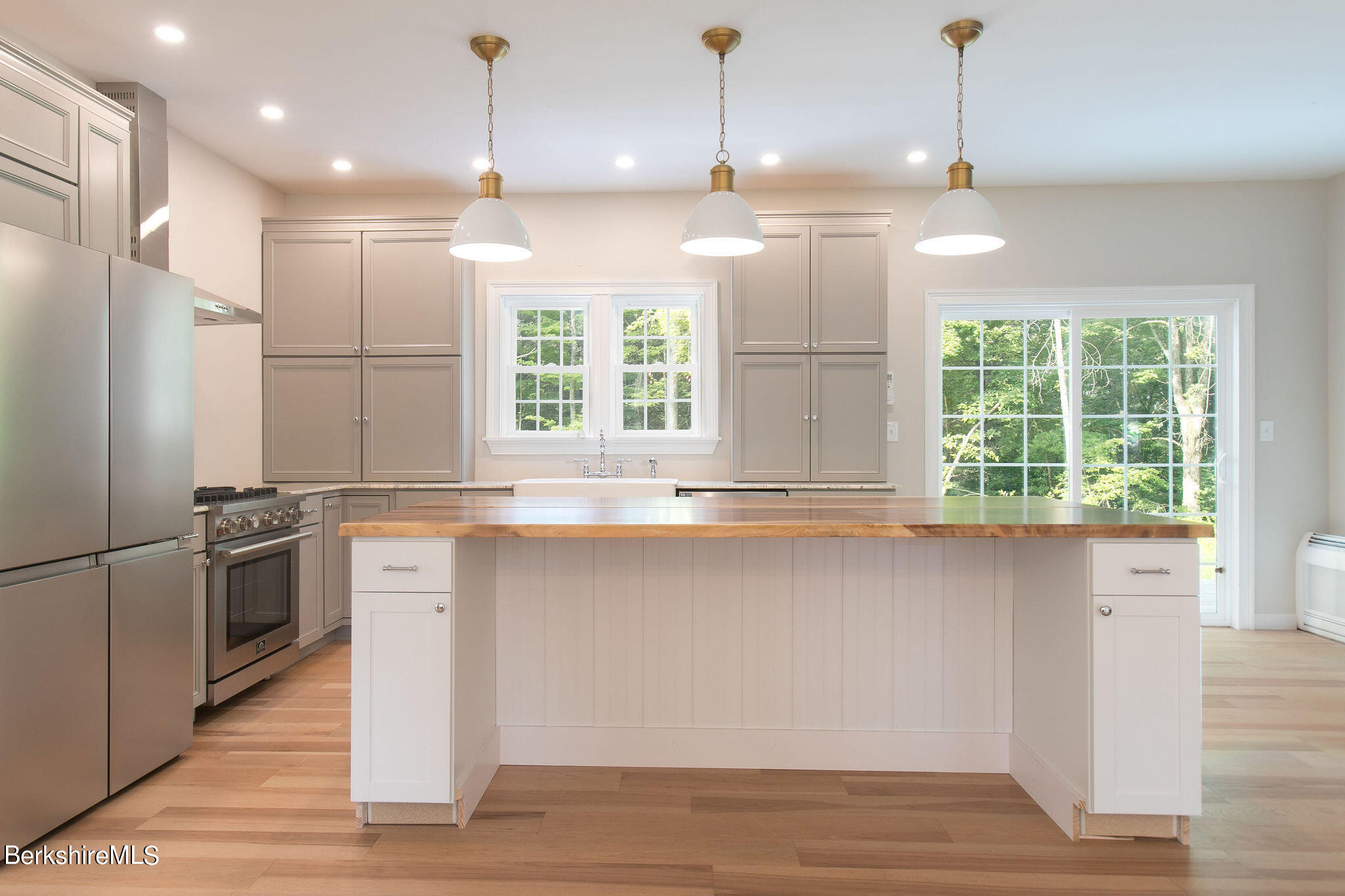 897 Canaan Valley Road New Marlborough, MA 01259 - Photo 8 of 50 a kitchen with granite countertop a stove a sink and a refrigerator