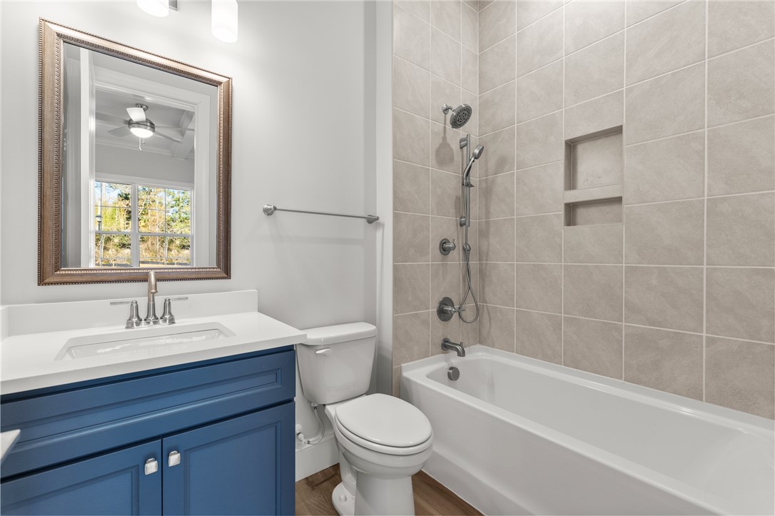 141 Rickys Path Easley, SC 29642 - Photo 26 of 40 This bright bathroom features a modern vanity and a tiled shower-tub combination.