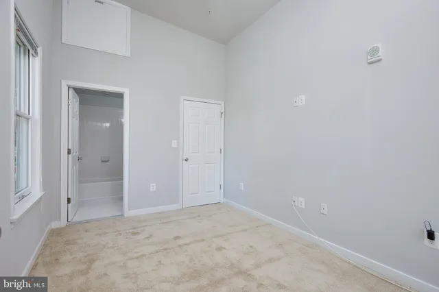 an empty room with closet area