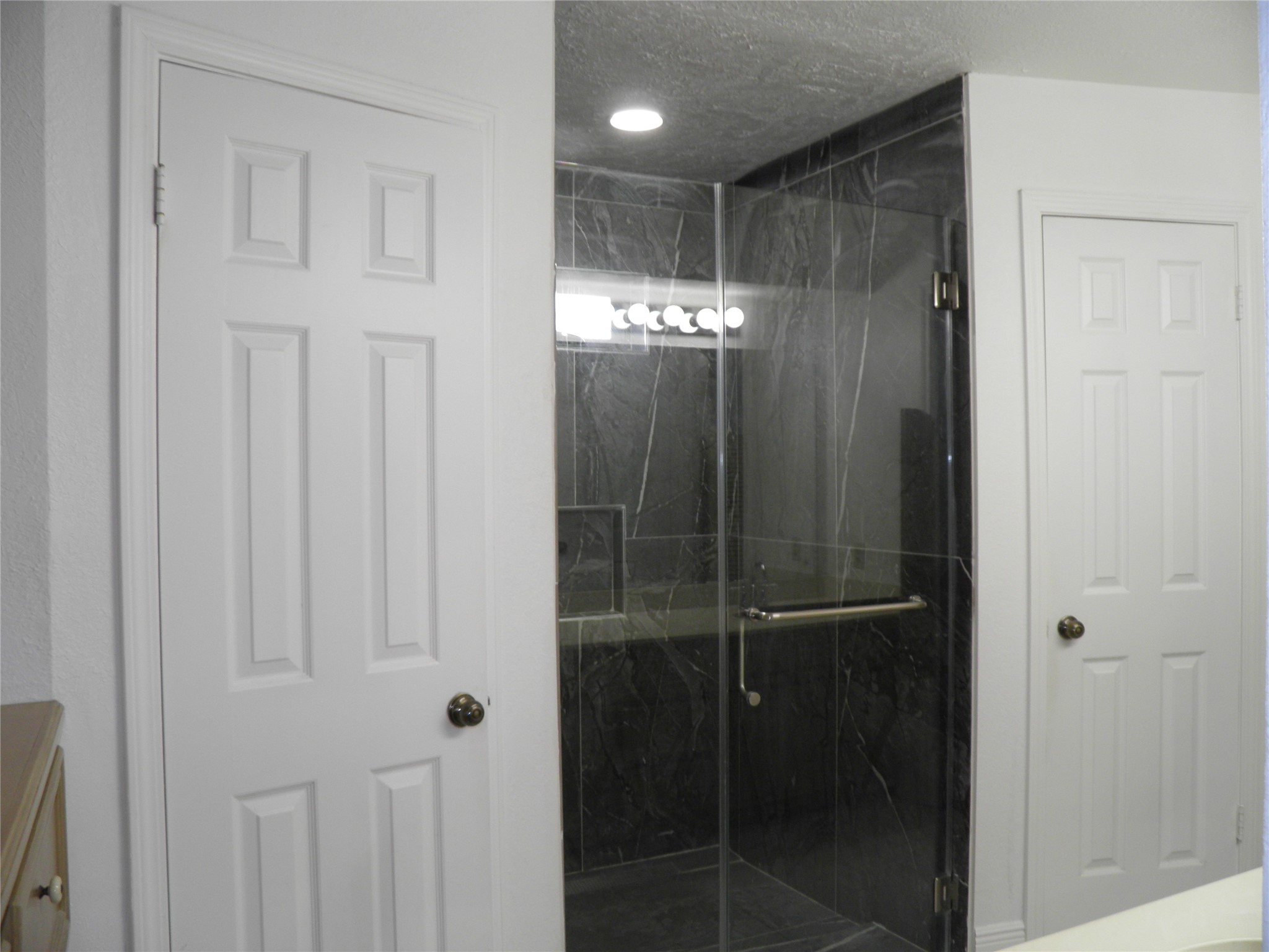 6819 Addicks Clodine Road Houston, TX 77083 - Photo 15 of 28 a bathroom with a glass shower door