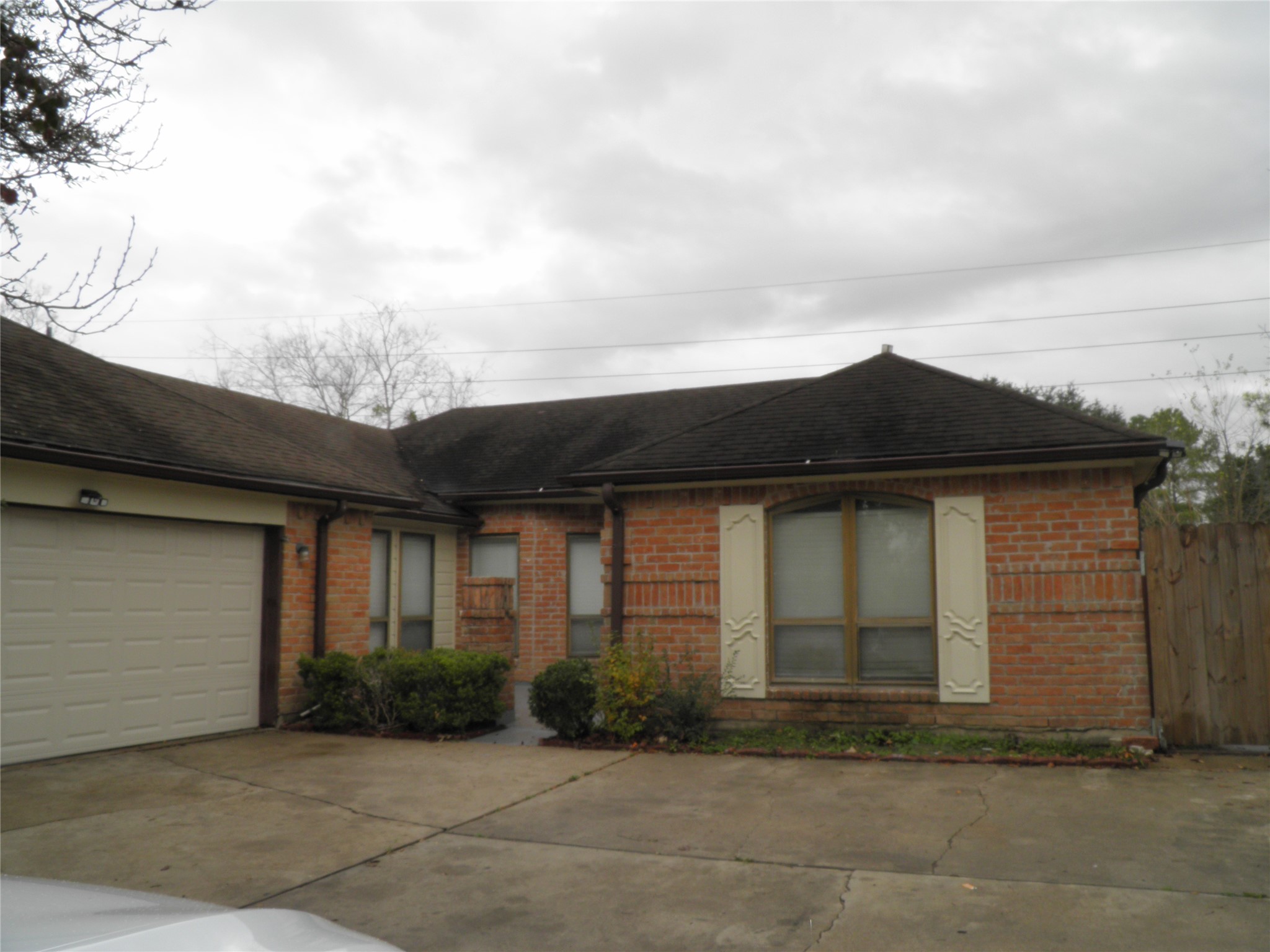 6819 Addicks Clodine Road Houston, TX 77083 - Photo 2 of 28 a front view of a house with a yard