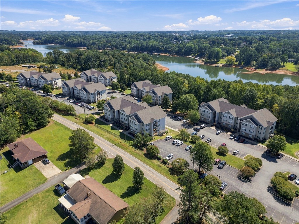 636 Lookover Drive Anderson, SC 29621 - Photo 5 of 34 Lush greenery surrounds this peaceful lakeside community under a clear blue sky.