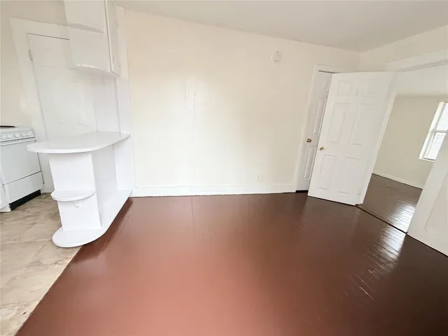 a view of water heater room with wooden floor