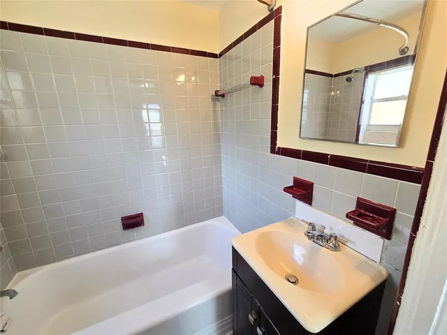 a bathroom with a sink shower and a mirror