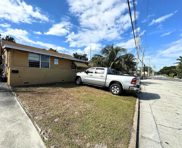 a view of a cars park in front of a building