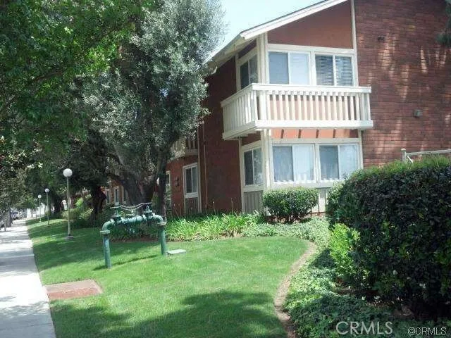 a view of a house with a yard and sitting area
