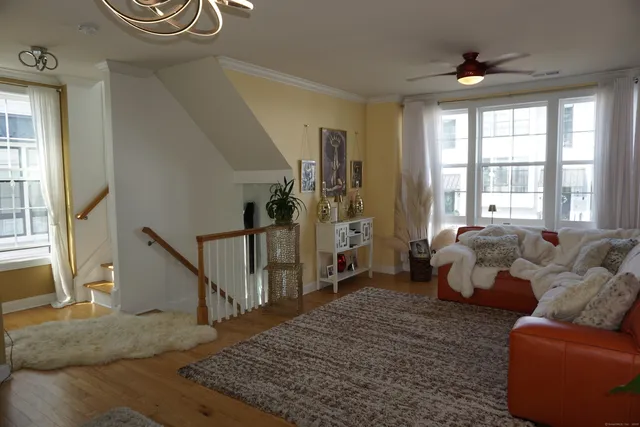 a living room with furniture and a floor to ceiling window