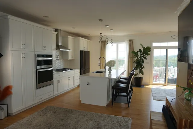 a view of a kitchen with dining table and chairs