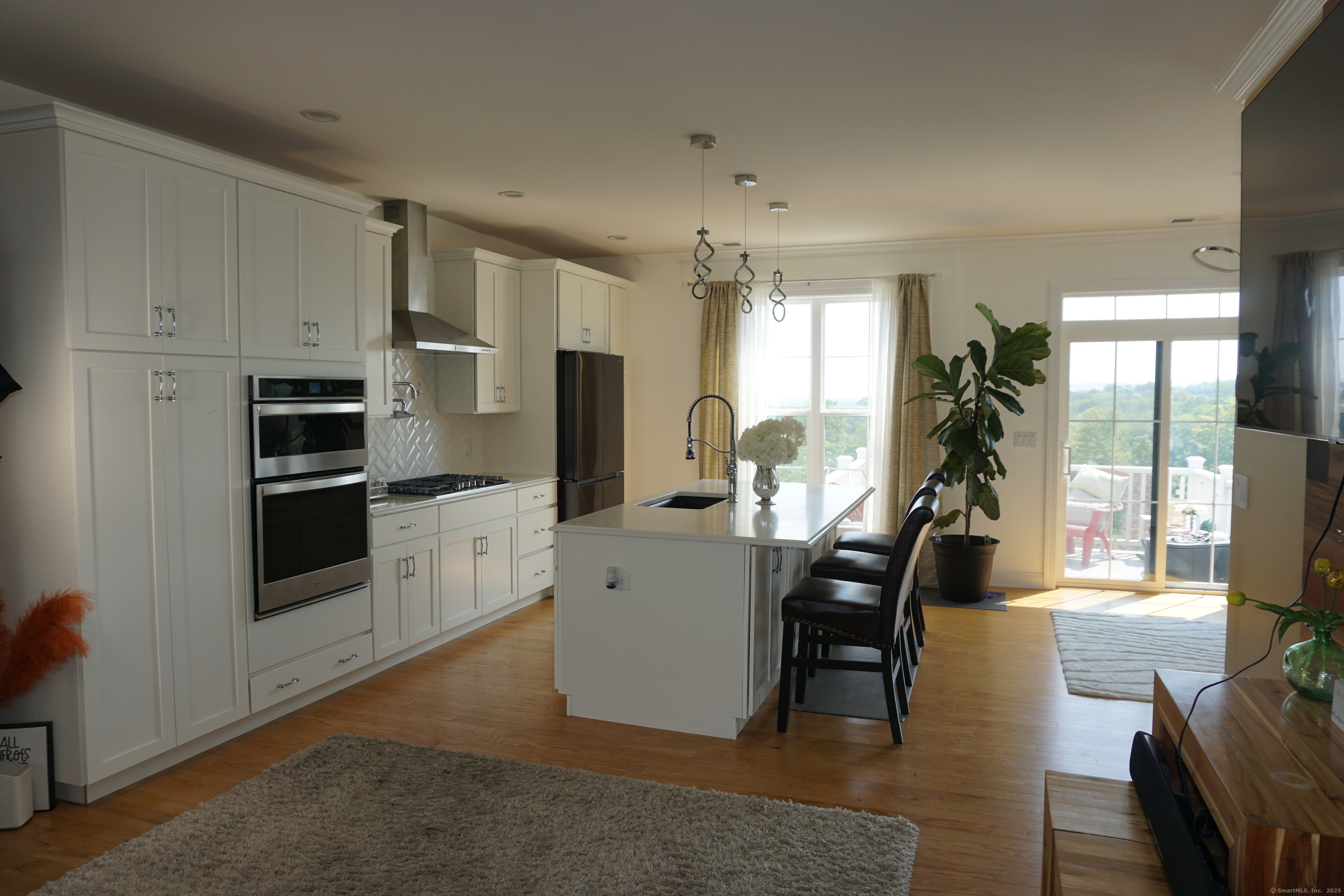 127 Brentwood Circle, Unit 127 Danbury, CT 06810 - Photo 4 of 23 a view of a kitchen with dining table and chairs