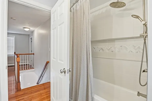 a bathroom with a bathtub and a shower