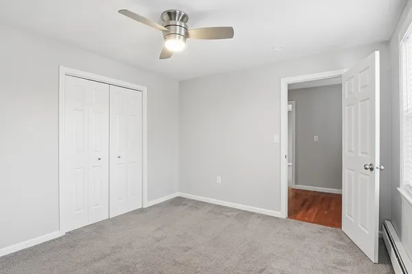 a view of room with chandelier fan