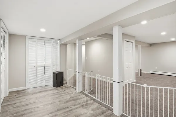 a view of a room with wooden floor
