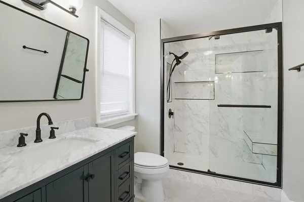 a bathroom with a sink toilet and shower