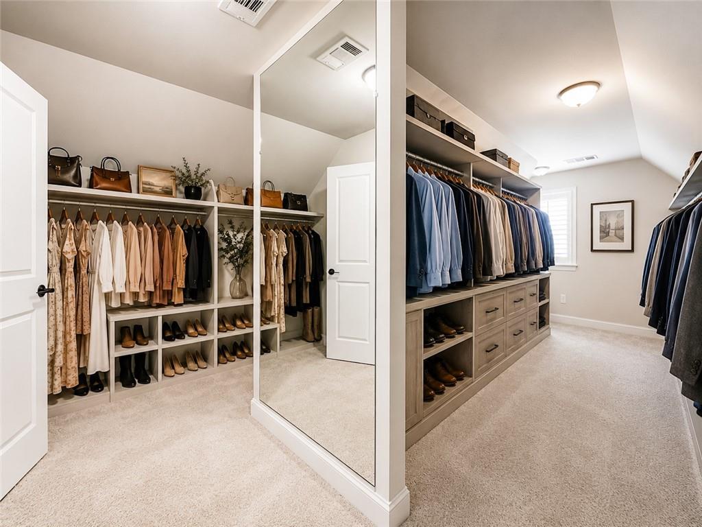 947 Hunter Way Milton, GA 30004 - Photo 55 of 78 a view of walk in closet with clothes and shoes