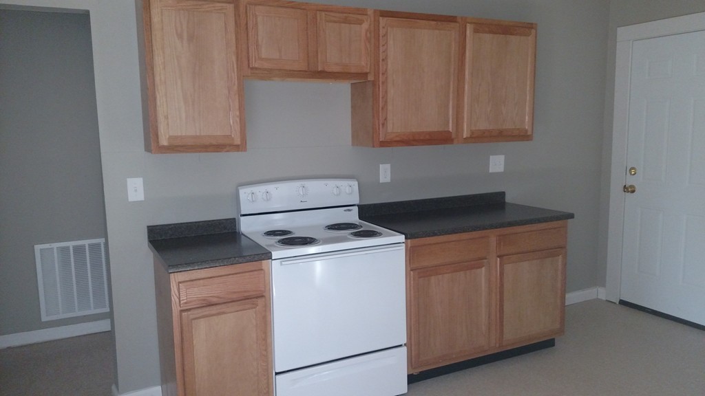 89-91 Cambridge Street Springfield, MA 01109 - Photo 2 of 9 a kitchen with granite countertop white cabinets and white appliances