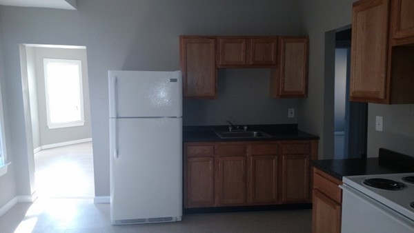 89-91 Cambridge Street Springfield, MA 01109 - Photo 4 of 9 a kitchen with a refrigerator and a stove