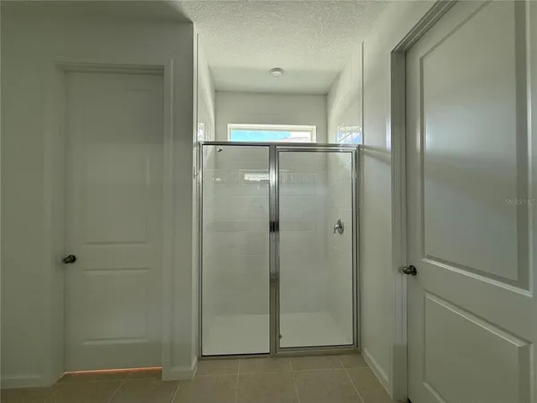 a bathroom with a glass shower door
