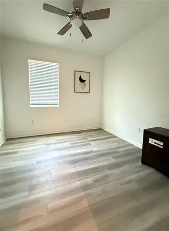 a view of a ceiling fan and hardwood floor