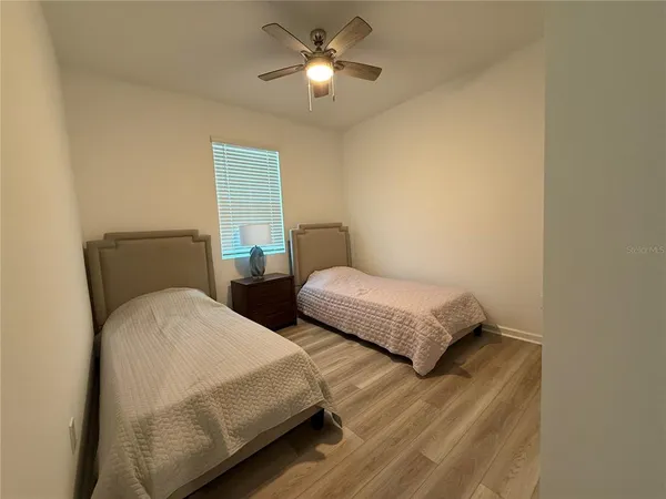 a bedroom with two beds and painted walls