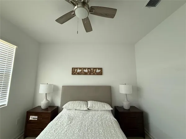 a bedroom with a bed and a night stand