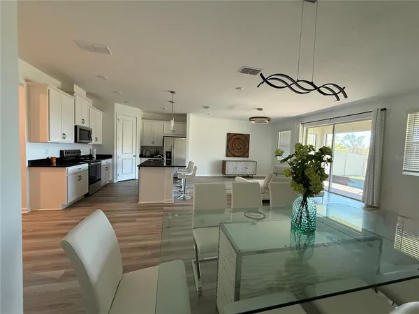 a view of kitchen with dining table and chairs