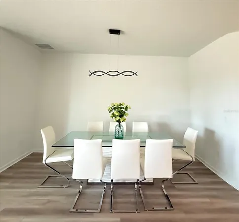 a dining room with furniture and wooden floor