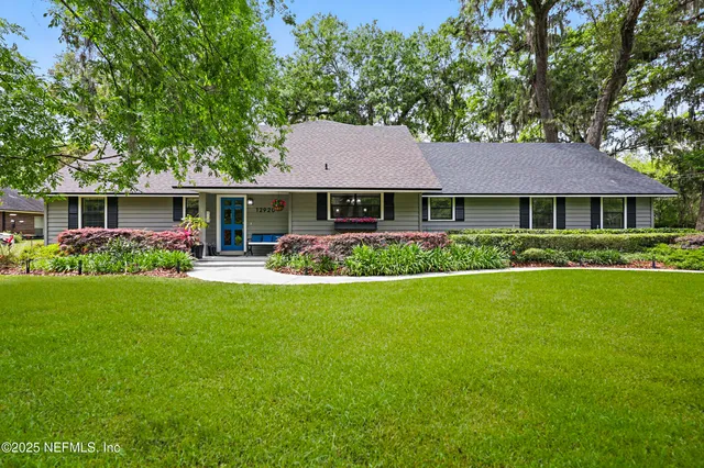 a front view of house with yard and green space